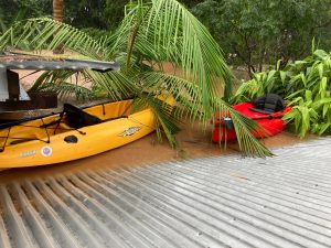 kayaks flooding at water level of the house roof